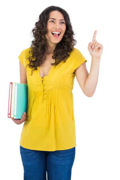 Happy curly haired student holding notebooks — Stock Photo, Image