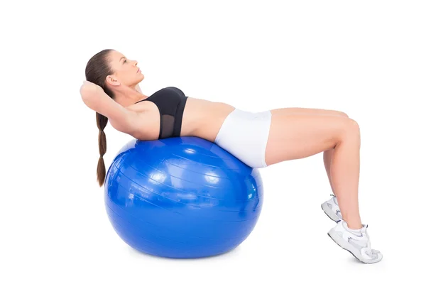 Concentrated fit woman working out with exercise ball — Stock Photo, Image