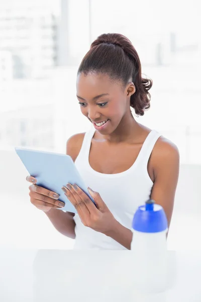Cheerful woman looking at her tablet pc — Stock Photo, Image