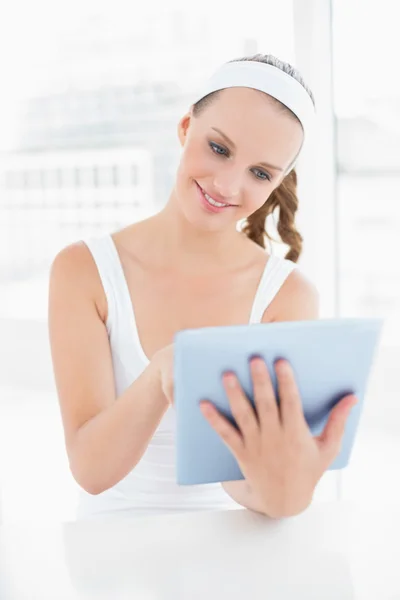 Peaceful pretty sportswoman using a tablet pc — Stock Photo, Image