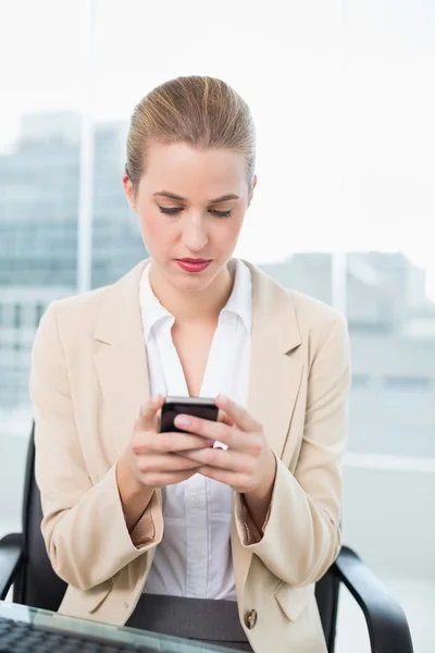 Serious attractive businesswoman text messaging — Stock Photo, Image