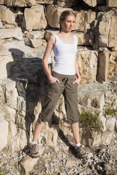 Athletic blonde on a hike with hands in pockets — Stock Photo, Image