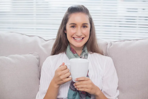 Cheerful pretty model holding cup of coffee — Stock Photo, Image