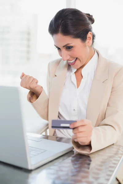 Aufgeregte Geschäftsfrau kauft online mit Laptop ein — Stockfoto