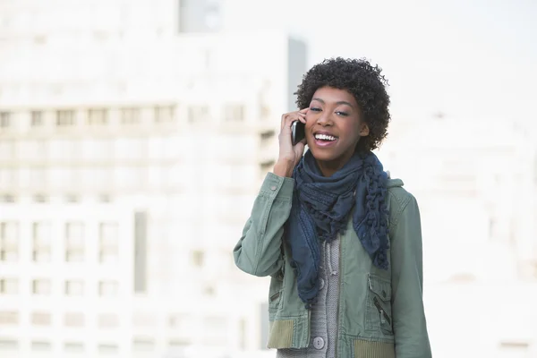 Smiling casual model on the phone — Stock Photo, Image