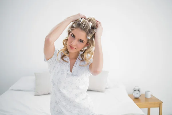 Happy pretty blonde wearing hair curlers posing — Stock Photo, Image