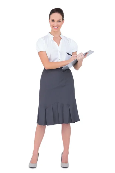 Beautiful businesswoman holding clipboard — Stock Photo, Image