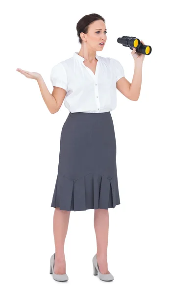 Disappointed elegant businesswoman holding binoculars — Stock Photo, Image