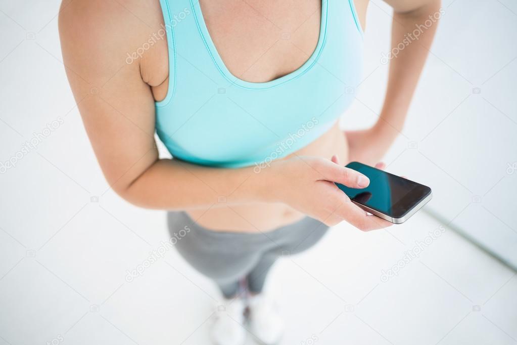 Woman in sportswear using her smartphone