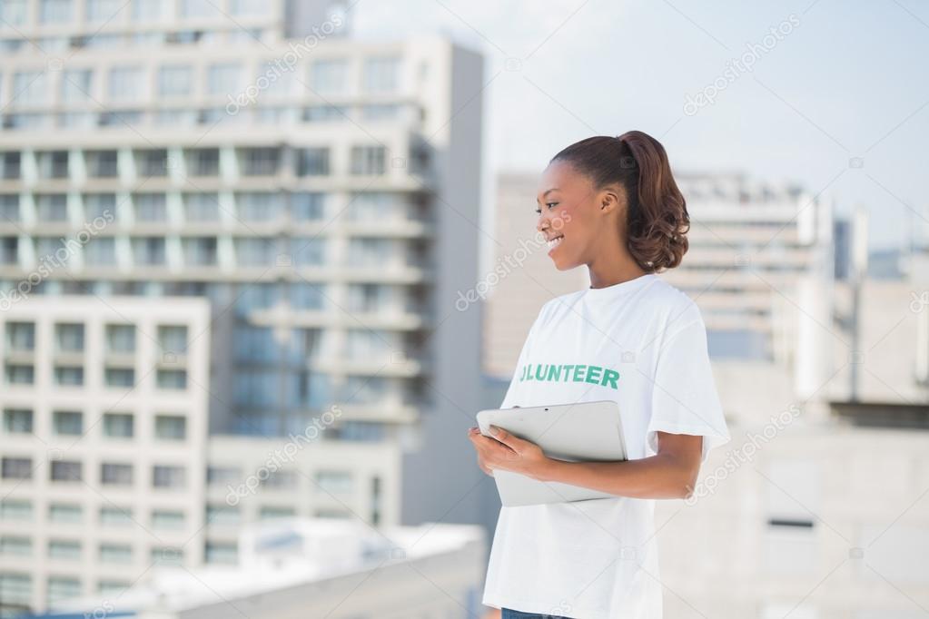 Cheerful volunteer woman holding clipboard