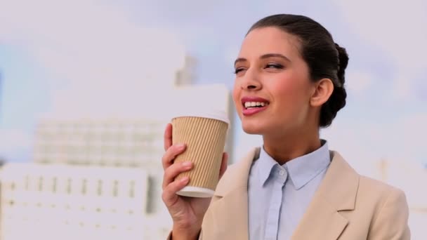Delighted beautiful businesswoman enjoying coffee — Stock Video