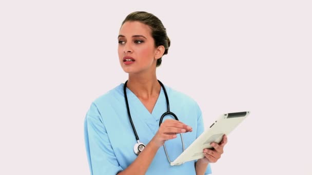 Thoughtful beautiful nurse using a tablet pc — Stock Video