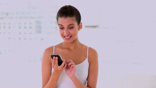 Concentrated beautiful woman looking at her mobile phone — Stock Video