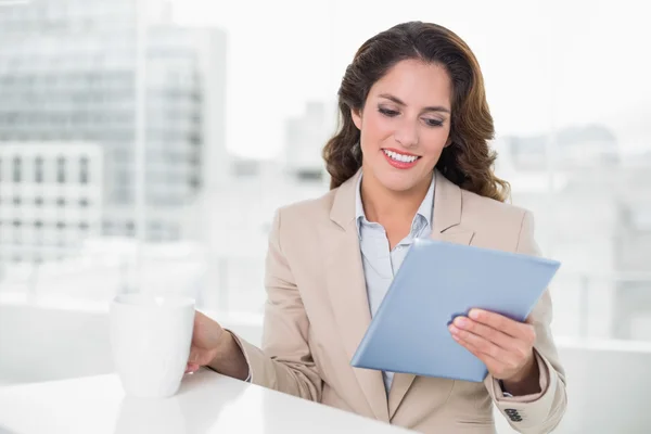 Beautiful content businesswoman using tablet — Stock Photo, Image