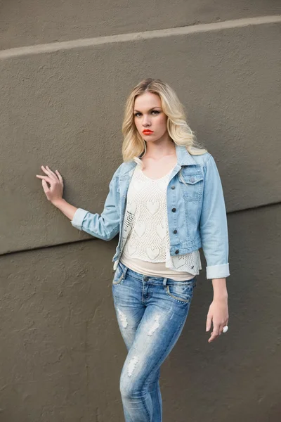 Stern casual blonde wearing denim clothes posing outdoors — Stock Photo, Image