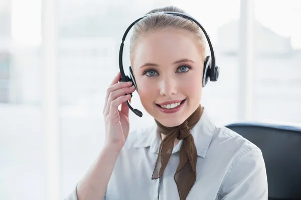 Blonde content businesswoman wearing a headset — Stock Photo, Image