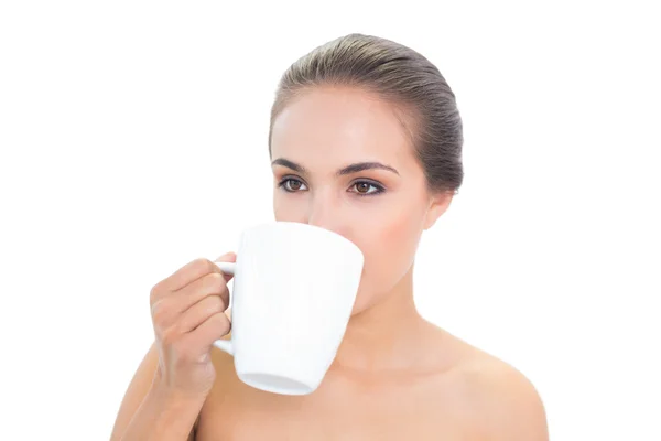 Lovely young woman drinking out of a mug — Stock Photo, Image