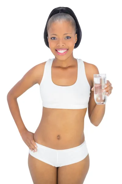 Fit smiling woman holding glass of water — Stock Photo, Image