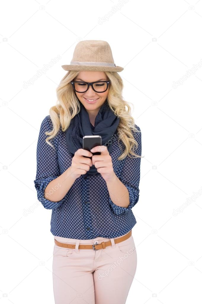 Smiling trendy blonde text messaging