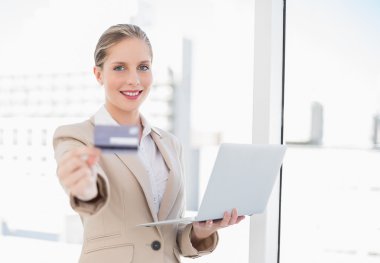 neşeli sarışın işkadını gösteren kredi kartı laptop holding