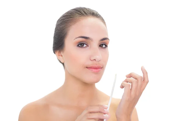 Content woman using a nail file — Stock Photo, Image