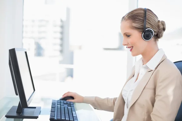 Smiling blonde call centre agent working — Stock Photo, Image
