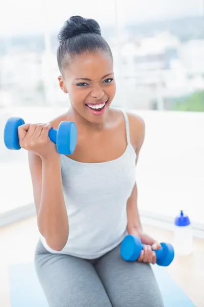 Exerted woman working out with dumbbell — Stock Photo, Image