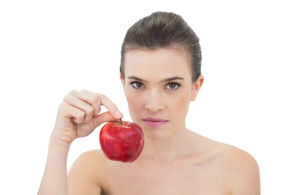 Stern model holding a red apple — Stock Photo, Image