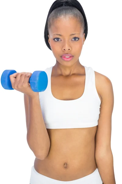 Mujer seria en ropa deportiva haciendo ejercicio con mancuerna —  Fotos de Stock