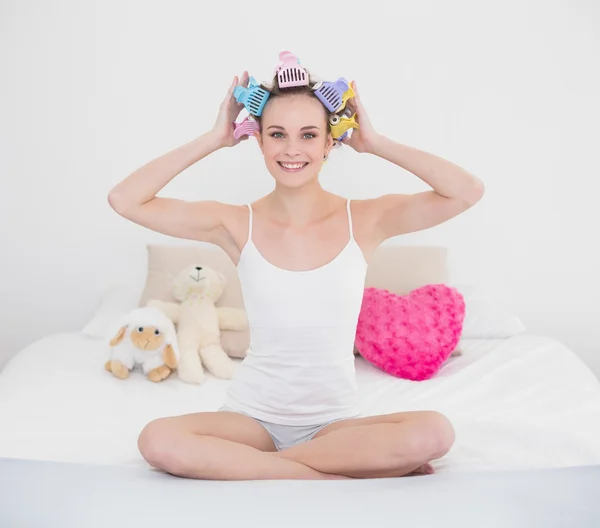 Pretty woman fixing her hair curlers — Stock Photo, Image