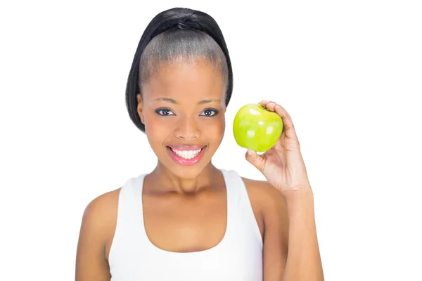 Attraktive Frau in Sportkleidung mit grünem Apfel — Stockfoto