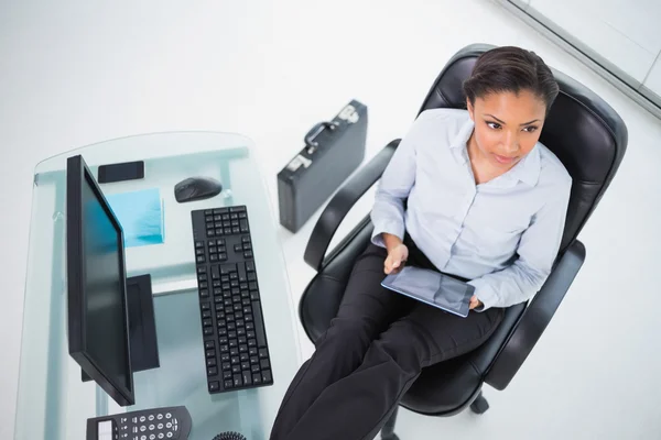 Pensive young businesswoman using a tablet pc — Stock Photo, Image