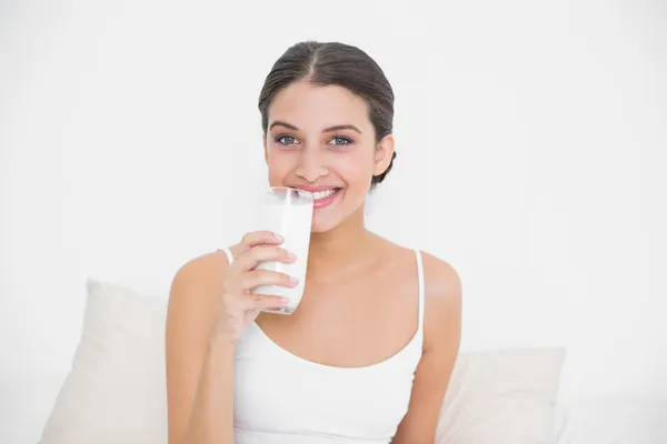 Model in white pajamas drinking milk — Stock Photo, Image