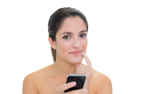 Thoughtful bare brunette using smartphone — Stock Photo, Image