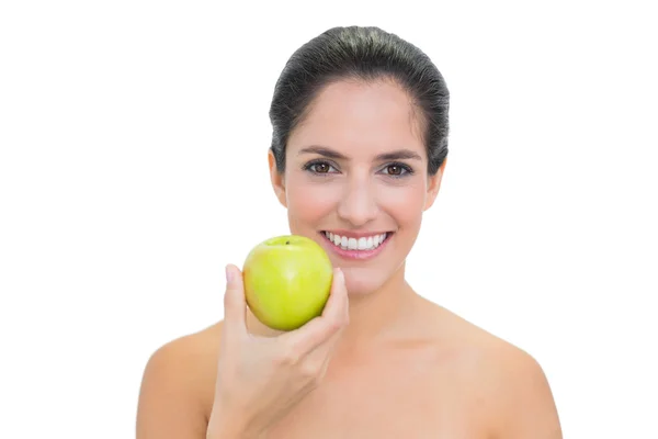 Smiling bare brunette holding green apple — Stock Photo, Image