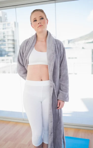 Serious sporty blonde wearing a bathing gown — Stock Photo, Image