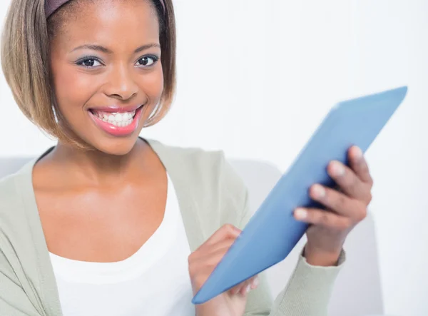 Gelukkig elegante vrouw zittend op de Bank met behulp van haar Tablet PC — Stockfoto