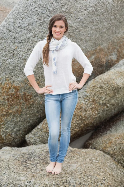 Pleased young model posing with hands on the hips — Stock Photo, Image