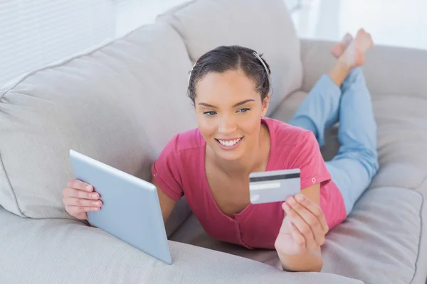 Женщина делает онлайн покупки с помощью планшета и кредитной карты — стоковое фото