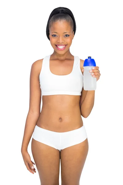 Smiling woman in sportswear holding sports bottle — Stock Photo, Image