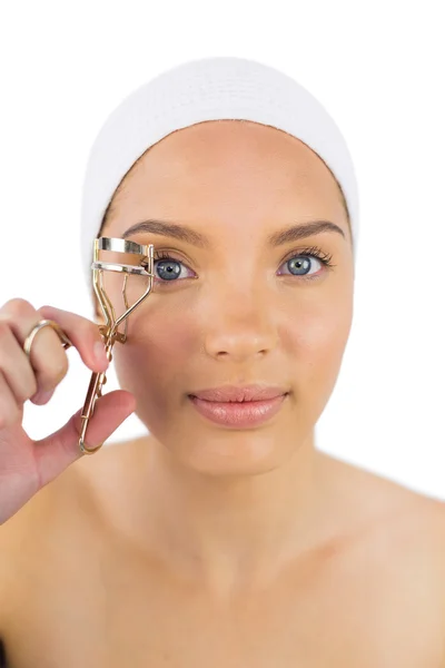 Attractive woman with headband using eyelash curler — Stock Photo, Image