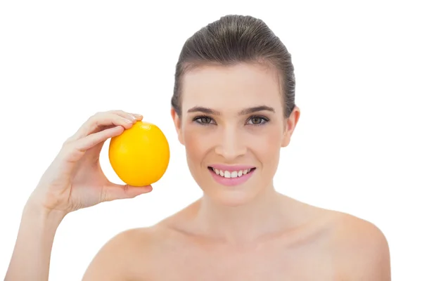 Laughing holding an orange — Stock Photo, Image