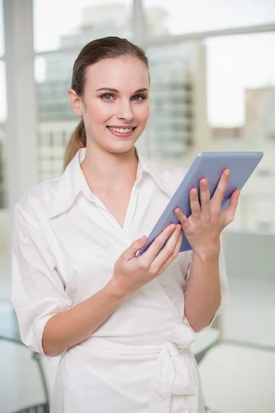 Happy businesswoman holding her tablet pc — Stock Photo, Image