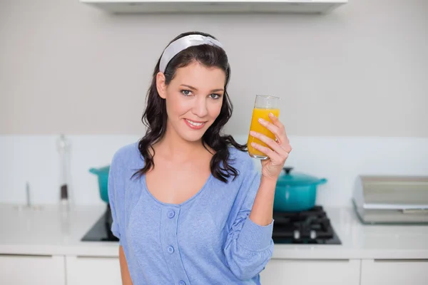 Content gorgeous model holding orange juice — Stock Photo, Image