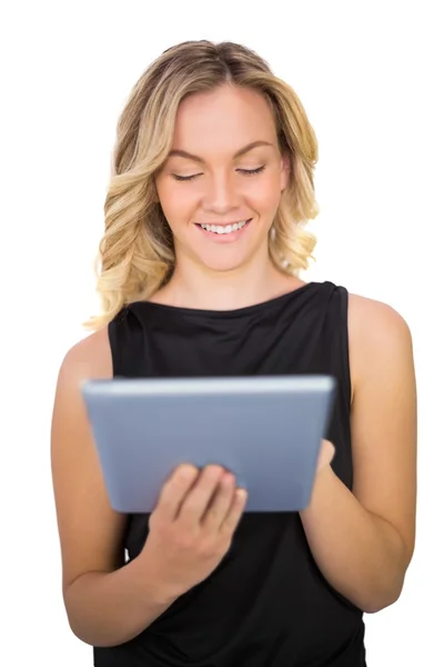 Leende vackra blonda i svart klänning med hjälp av Tablet PC — Stockfoto