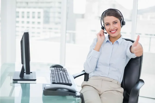 Cheering operator raising her thumb — Stock Photo, Image