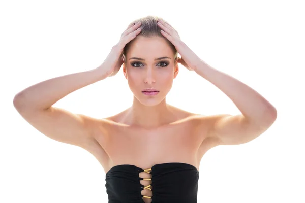 Serious attractive blonde model holding her head — Stock Photo, Image