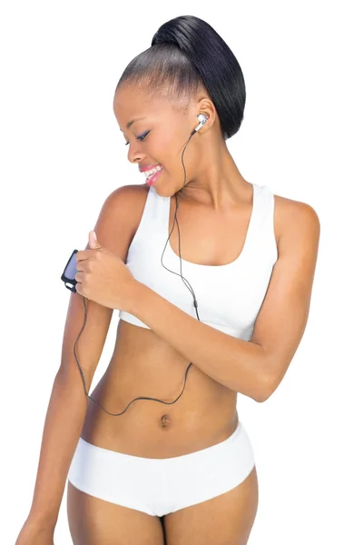 Fit woman in sportswear using music player — Stock Photo, Image
