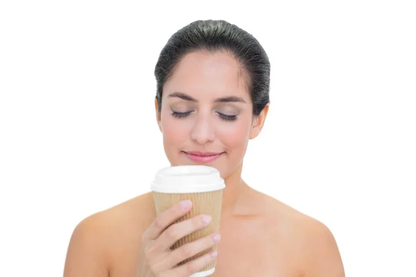 Smiling bare brunette smelling disposable cup — Stock Photo, Image