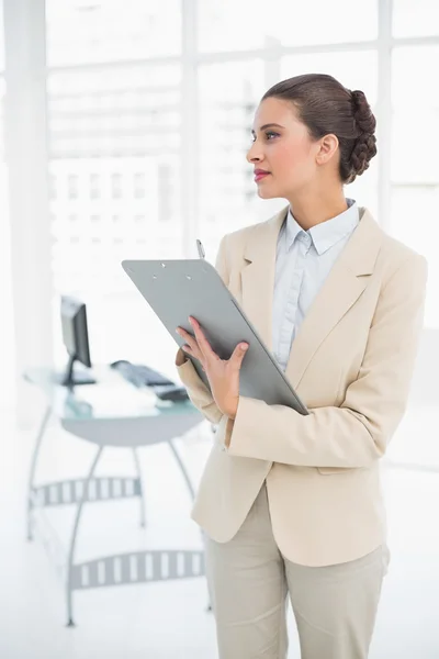 Thinking smart businesswoman checking a report — Stock Photo, Image